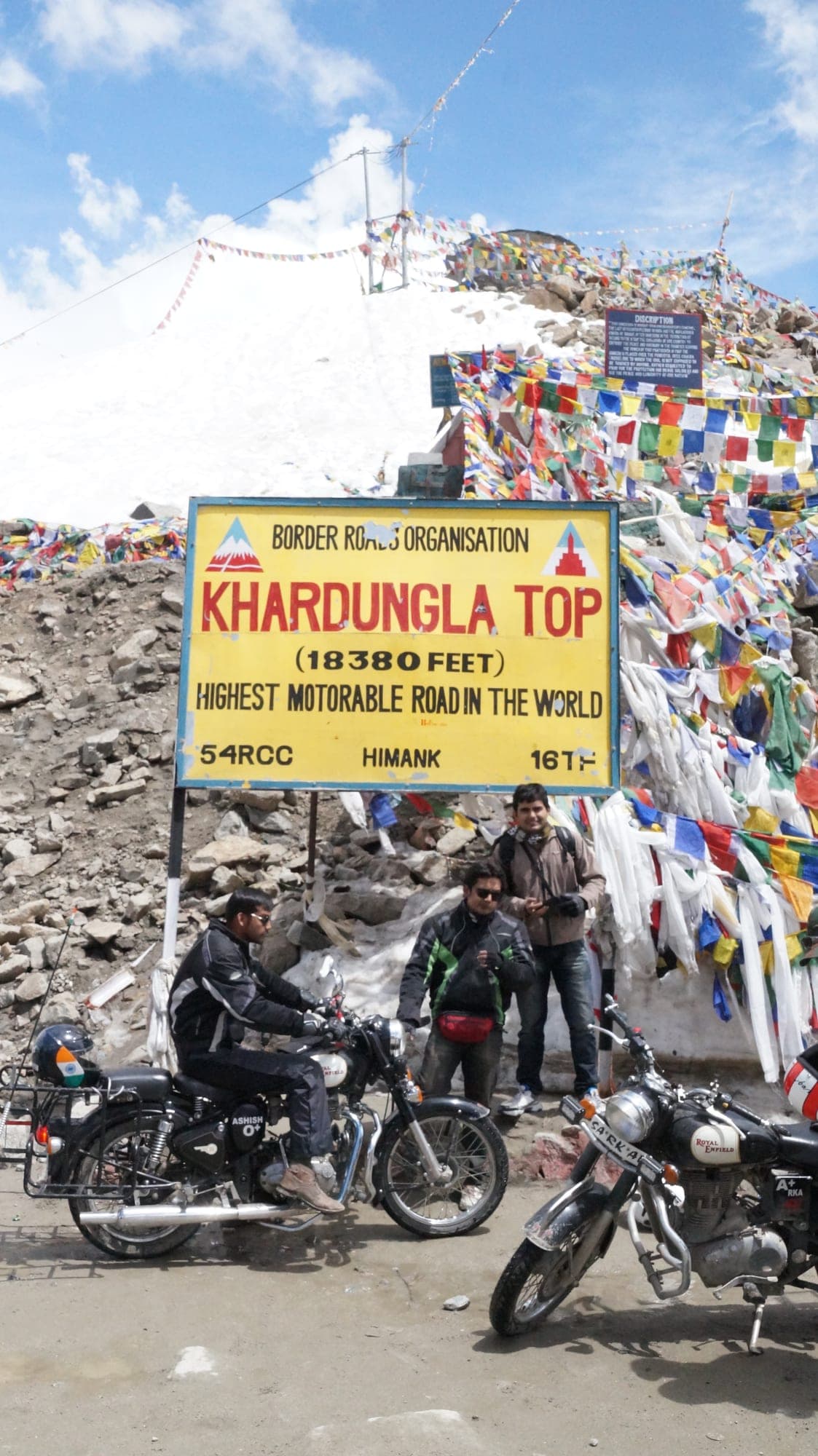 Motorcyclist riding the winding mountain road up to Khardung La pass in Ladakh